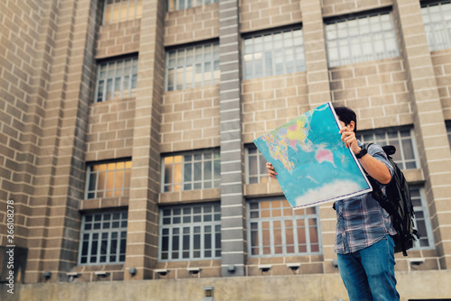 Fotografie Tourist man searching right direction with map on the street