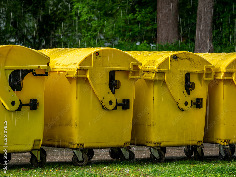 Image of Yellow waste Containers, Recycling bin for special Rubbish, during hail and rainy weather Image of Yellow waste Containers, Recycling bin for special Rubbish, during hail and rainy weather