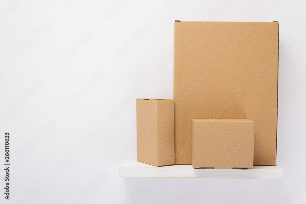 cardboard box on wooden shelf cardboard box on wooden shelf