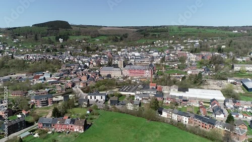 Aerial bird view footage flight towards Abbey of Stavelot located in the Walloon municipality in Belgian province of Liege at Ardennes region popular tourist destination know by beautiful nature 4k photo