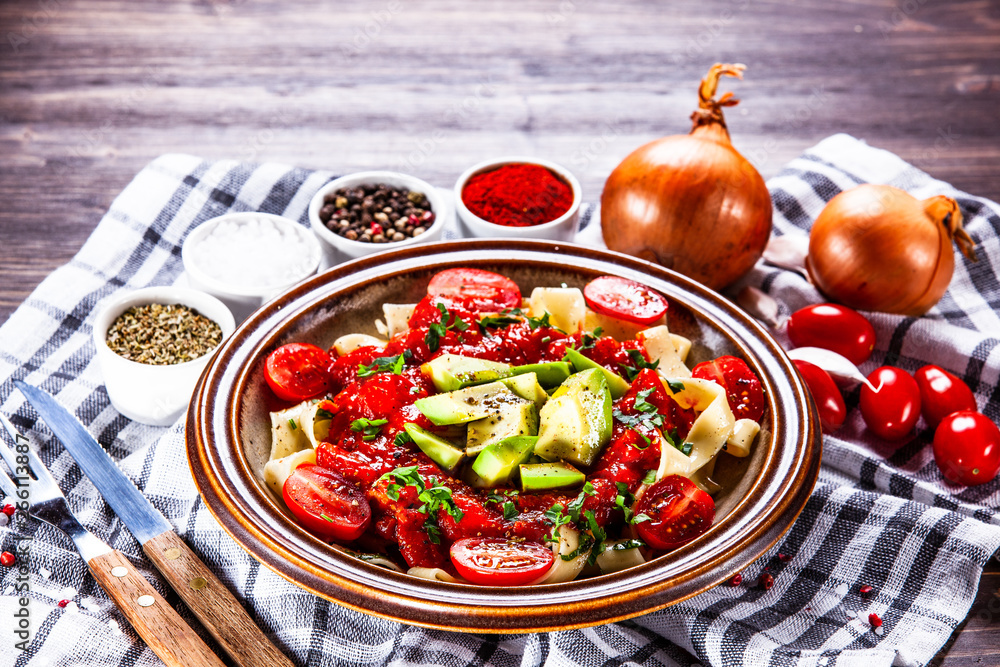 Pasta with herbs and vegetables on wooden background Pasta with herbs and vegetables on wooden background