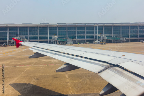 Aircraft wing view from inside plane with aire port at Yangon photo