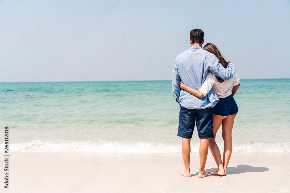 Romantic lovers young couple relaxing together on the tropical beach.Man hugging with woman and enjoy life.Summer vacations Romantic lovers young couple relaxing together on the tropical beach.Man hugging with woman and enjoy life.Summer vacations