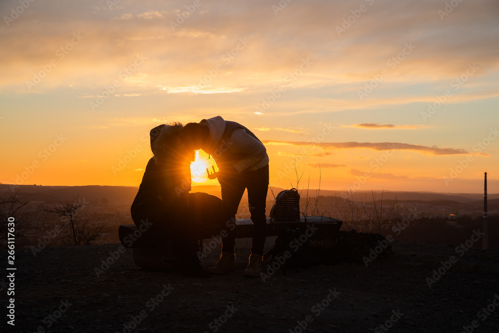 Girl taking photos during colored sunset in quarry Hady Brno with view inside city Girl taking photos during colored sunset in quarry Hady Brno with view inside city