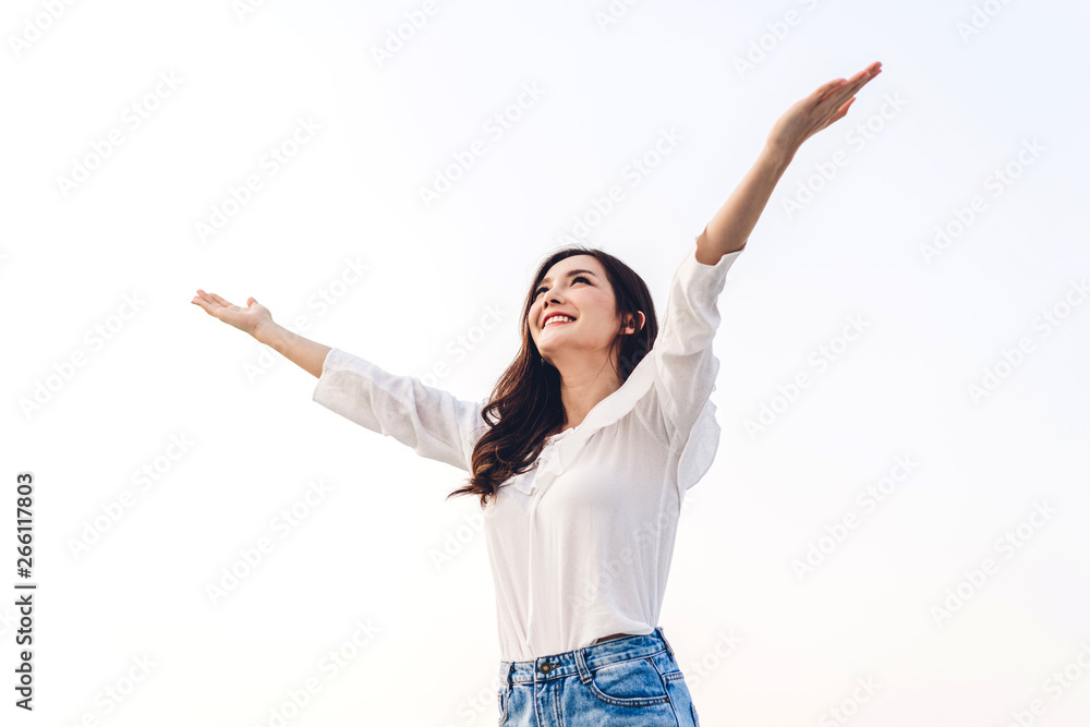 Woman standing stretch her arms relax and enjoy with nature fresh air