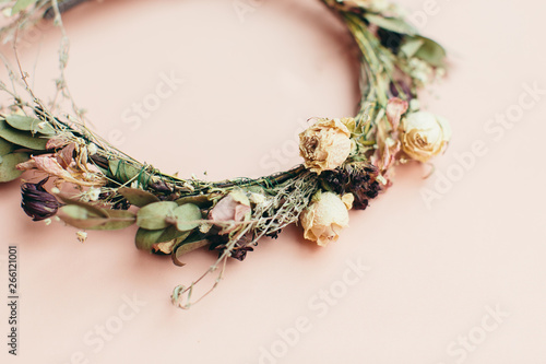 dried wreath of flowers on a pink background (wedding)