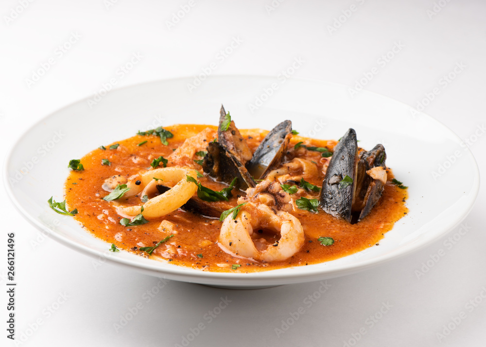 Fish soup with seafood, prawns, mussels and squid in a tomato sauce Fish soup with seafood, prawns, mussels and squid in a tomato sauce