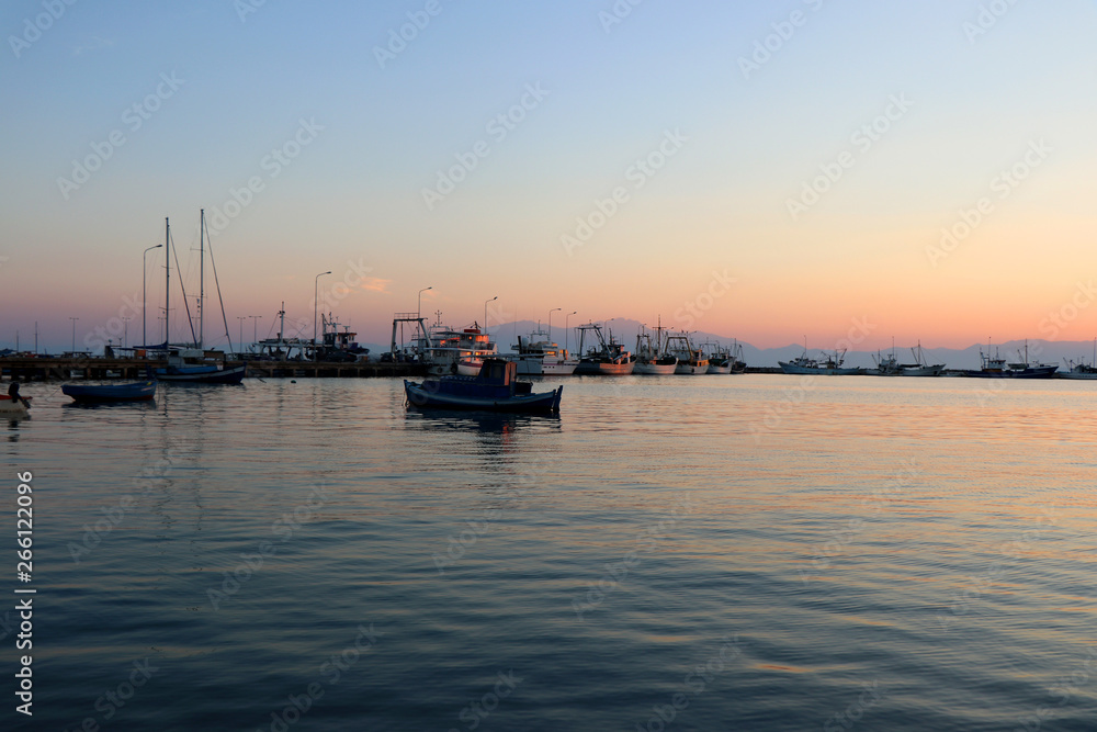 Sunset in the port of Nea Michaniona, suburb of Thessaloniki, Greece. View of the ships. 
