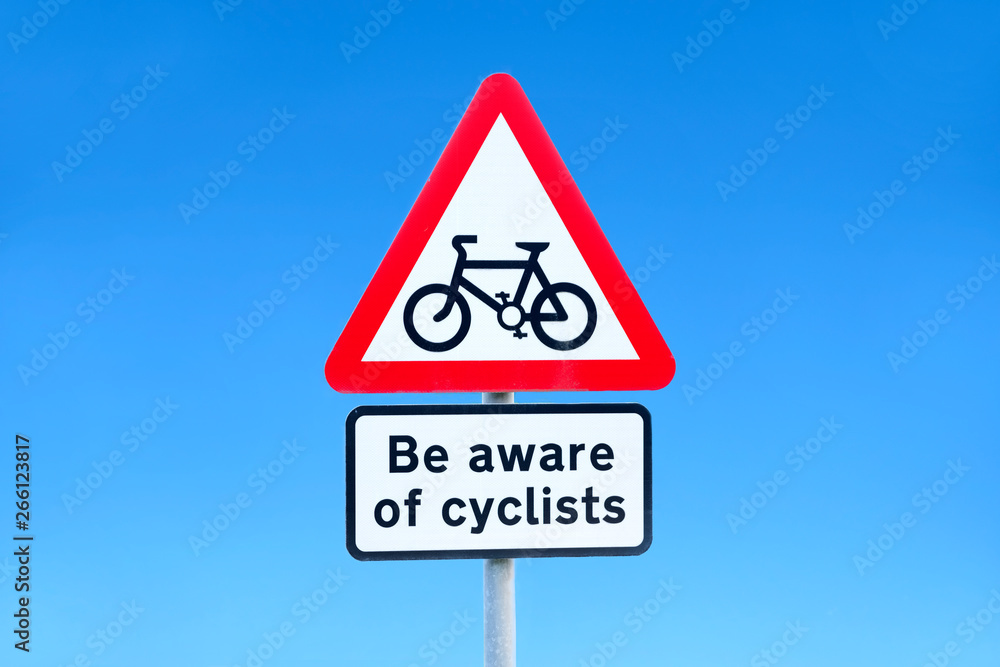 Beware of cyclists road safety sign against blue sky Beware of cyclists road safety sign against blue sky