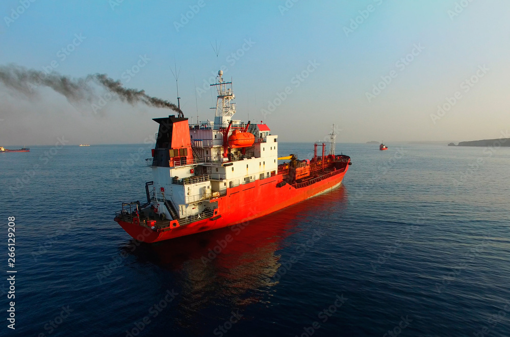 Fototapeta premium Aerial view of the seascape with a red ship against the sea background.