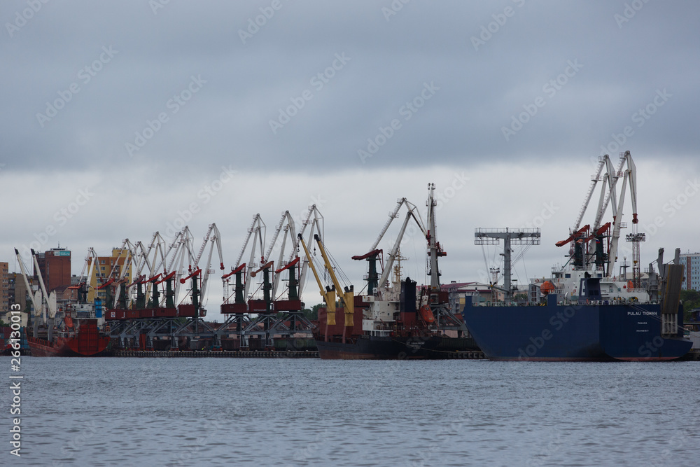 Vladivostok Commercial Sea Port. Container terminal in the port. Industrial marine facade of Vladivostok.