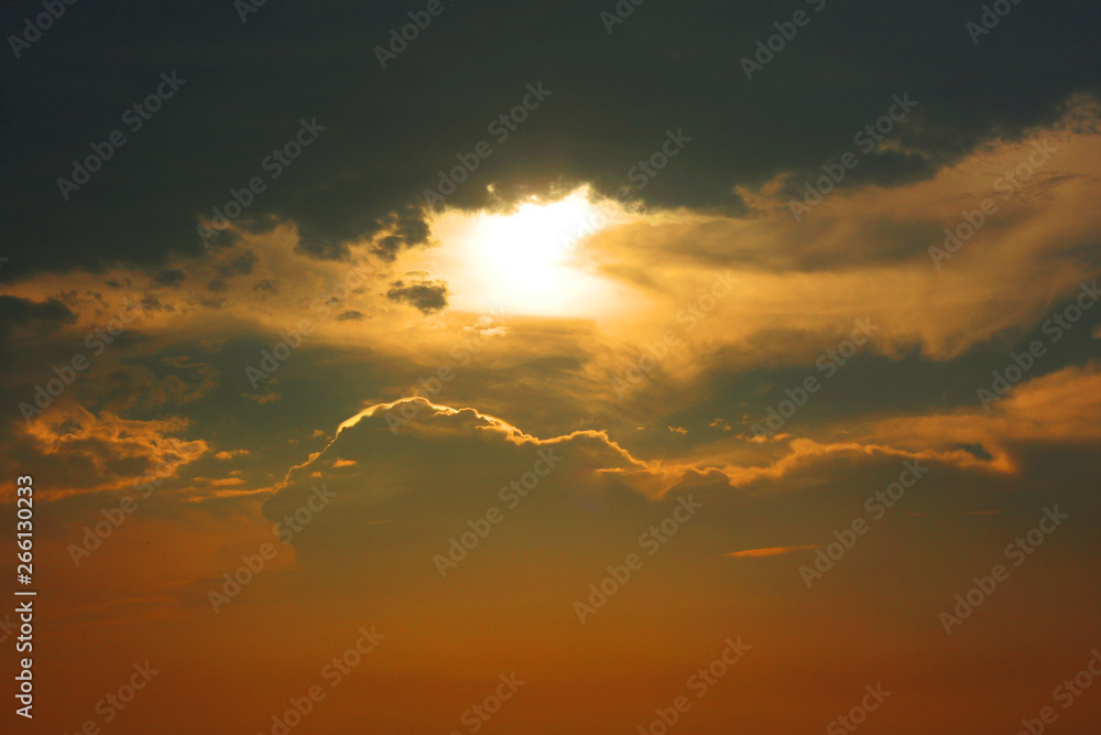Dramatic golden light of sunray in sunset with clouds.