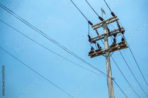 High voltage cables and equipments on pole with clear blue sky background and copy space