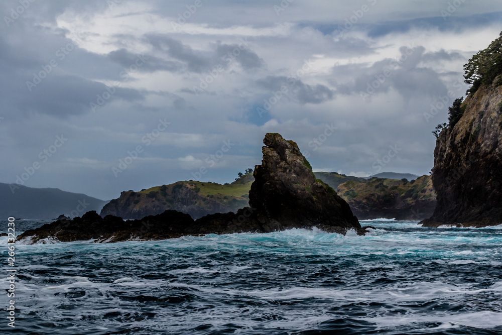 Waves crash against the rocks, Bay of Islands, New Zealand Waves crash against the rocks, Bay of Islands, New Zealand