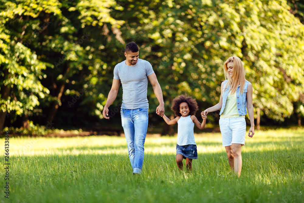 Happy young couple spending time with their daughter