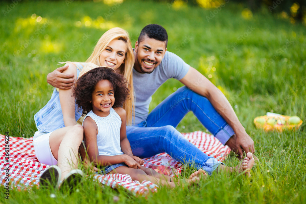 Picture of lovely couple with their daughter having picnic Picture of lovely couple with their daughter having picnic