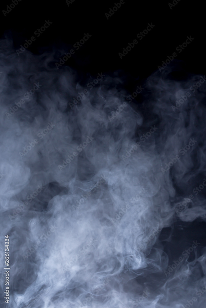 Smoke and fog in front of black background. Concept graphic elements.