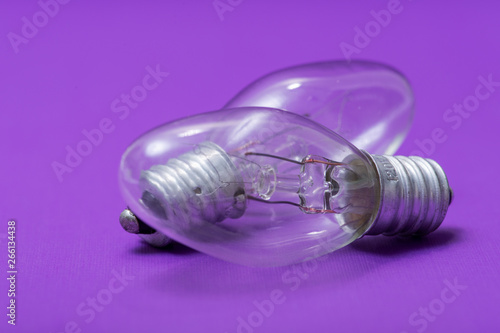 Clear Incandescent Night Light Bulbs with candelabra base on purple background.