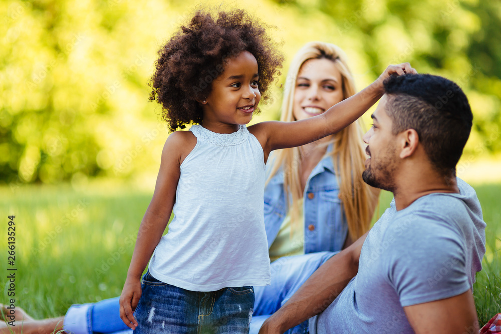 Picture of lovely couple with their daughter having picnic Picture of lovely couple with their daughter having picnic