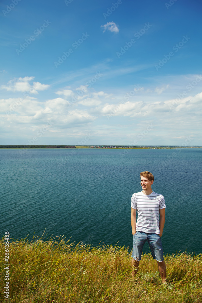 Fototapeta premium Portrait of ayoung smiling man summer outdoors