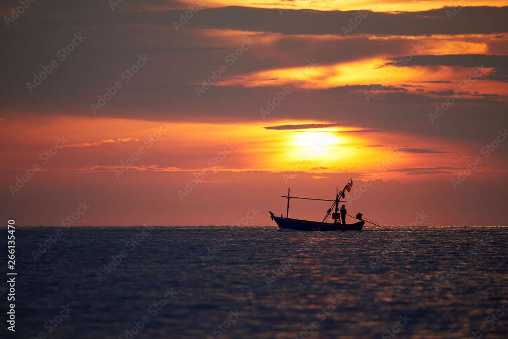 Silhouette of a fisherman on longtail boat
