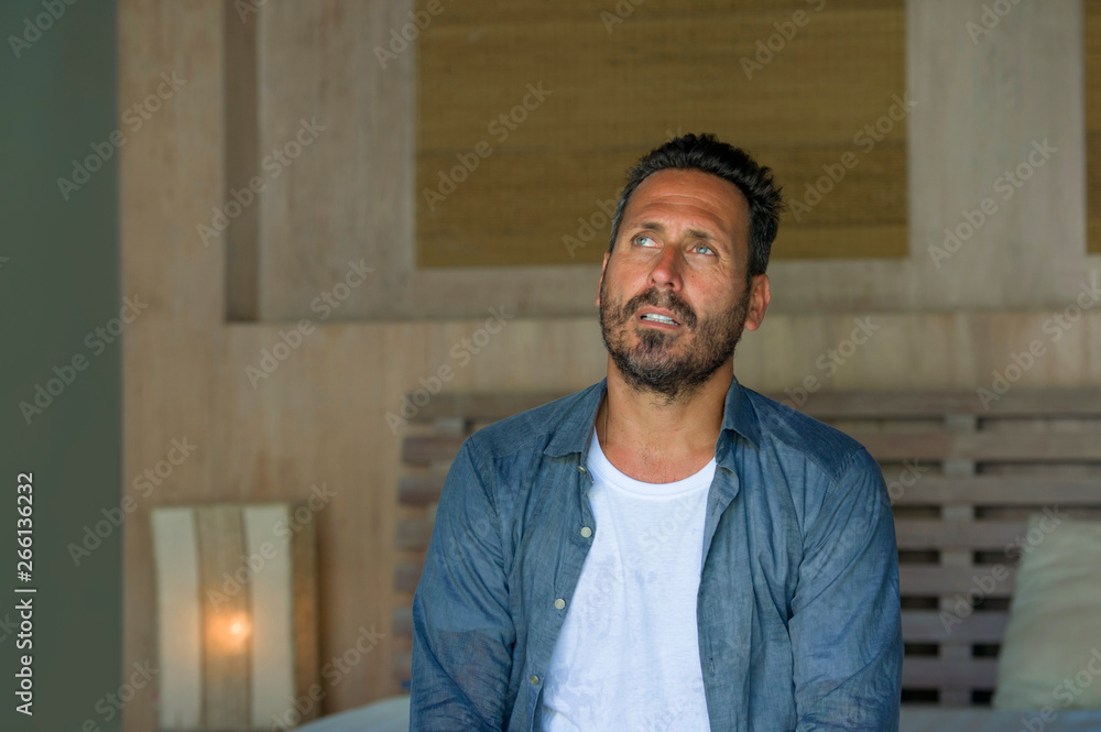 young attractive stressed and depressed man sitting on bed crying sad and frustrated suffering depression crisis fired from work or divorce problem feeling pain young attractive stressed and depressed man sitting on bed crying sad and frustrated suffering depression crisis fired from work or divorce problem feeling pain