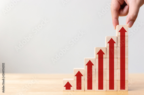 Ladder career path for business growth success process concept.Hand arranging wood block stacking as step stair with arrow up