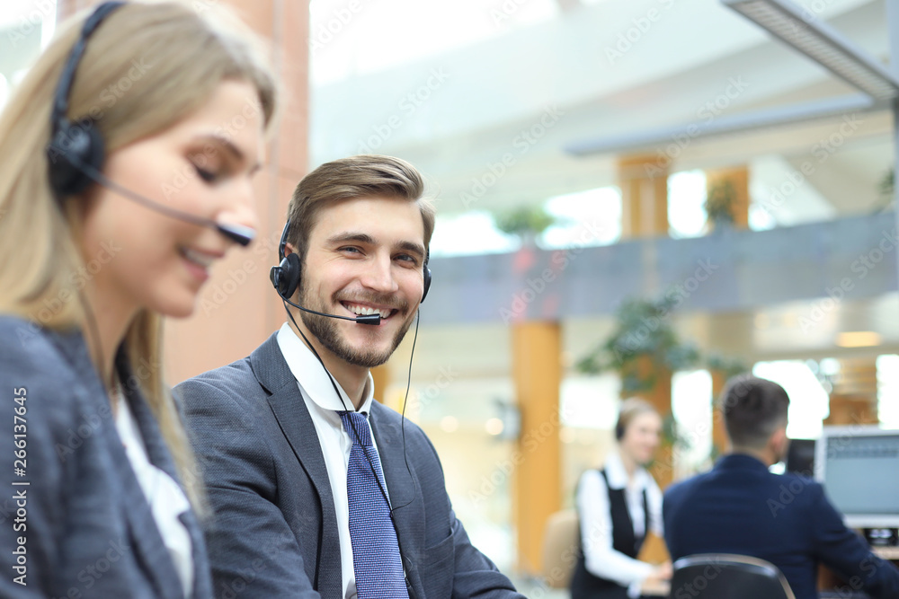 Happy young male customer support executive working in office. Happy young male customer support executive working in office.