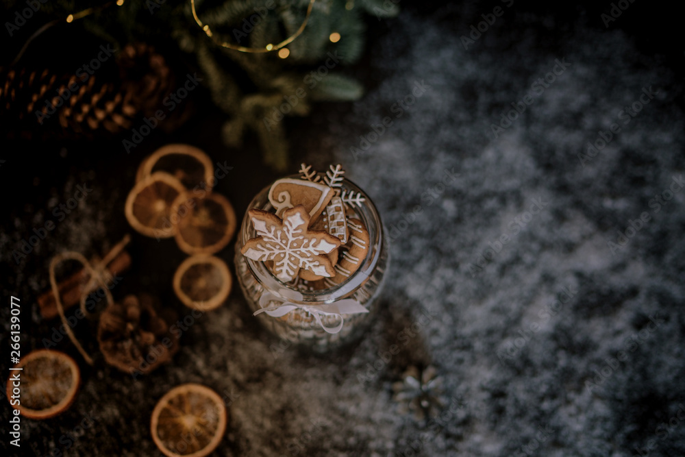 Christmas gift with homemade gingerbread cookies, nuts and chocolates. Glass jar, fir branches, Christmas spices and decor. Winter holidays, New Year or Christmas concept. Top view with copy space. Christmas gift with homemade gingerbread cookies, nuts and chocolates. Glass jar, fir branches, Christmas spices and decor. Winter holidays, New Year or Christmas concept. Top view with copy space.