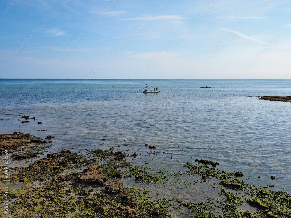 Flats fishermen off the Fossilized Reef in Bear Cut on Key Biscayne, Florida, at low tide.