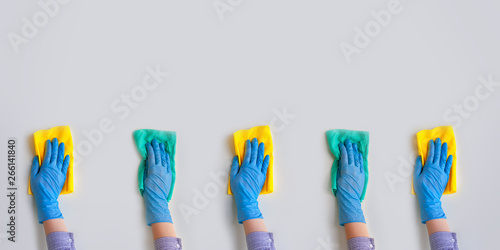 Commercial cleaning company. Employee hands in blue rubber protective glove. General or regular cleanup.