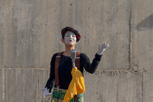 Mime on the street singing with microphone photo