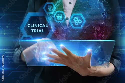 The concept of business, technology, the Internet and the network. A young entrepreneur working on a virtual screen of the future and sees the inscription: Clinical trial photo