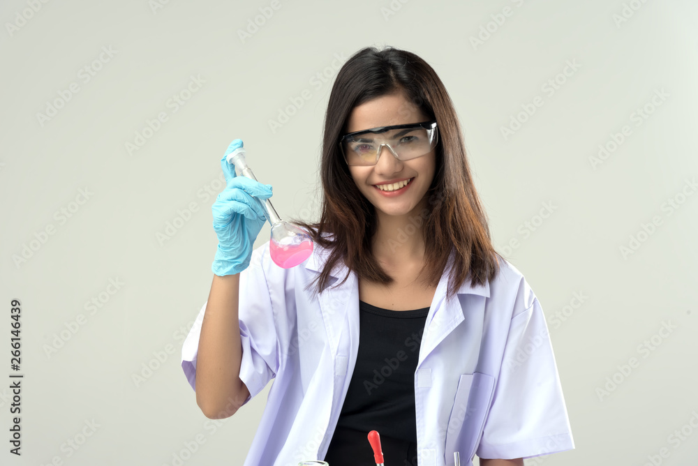 Cheerful chemist woman in lap, or graduate student in lab coat ane protetive wear work,check and test chemistry. Cheerful chemist woman in lap, or graduate student in lab coat ane protetive wear work,check and test chemistry.