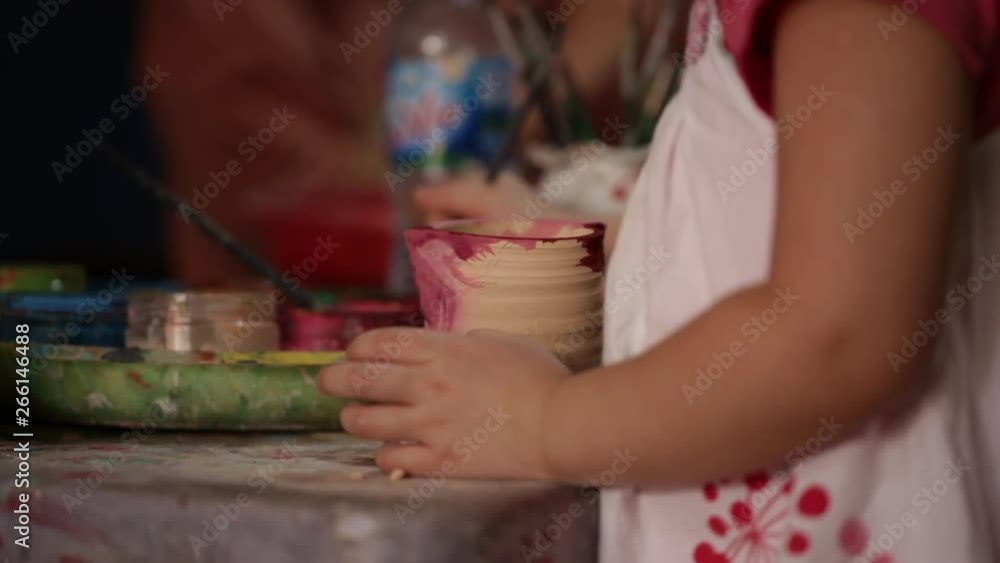 Kid's hands at pottery workshop. Designing pottery products Kid's hands at pottery workshop. Designing pottery products