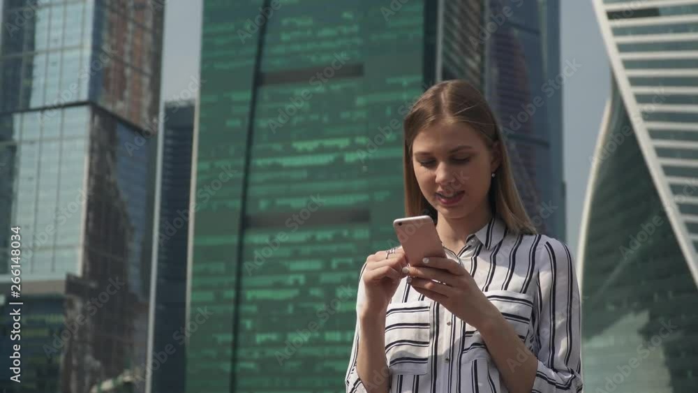 Woman student walking city outdoor call phone, talking phone audio message happy girl skyscrapers on background