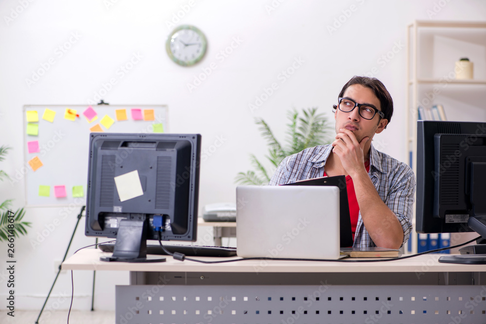 Male it specialist working in the office Male it specialist working in the office