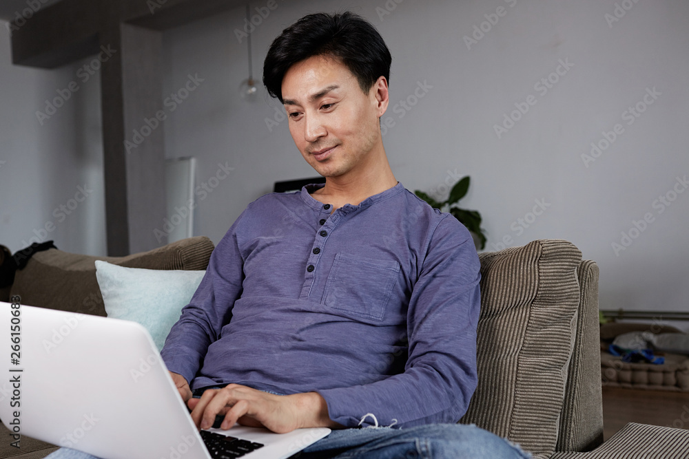 Asian Man Gay Working Laptop Home Connecting Networking Concept.