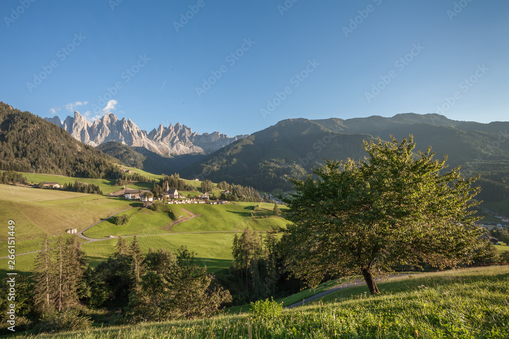 Fototapeta premium Small Italian mountain town of St. Magdalena in Val di Funes at sunset