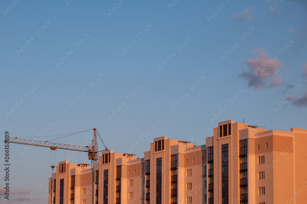 Construction of an apartment building. Upper part on the background of the tower crane Construction of an apartment building. Upper part on the background of the tower crane