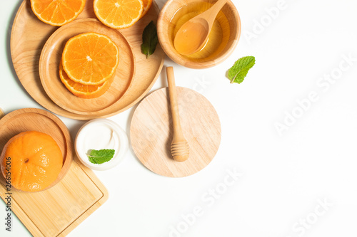 orange fruit juice with wood dinner dish and cosmetic spa lotion facial cream for skin care  ingedients of food and healthy  oil herb natural  top view  summer season  nutrition of vitamin c