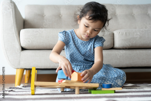 This one asian little girl is playing in the lhome .she smile very happily photo