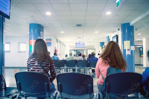 people in a waiting room of hospital, men and women wait their turn  photo