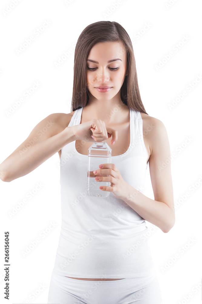 Attractive young woman drinking water on isolated white background. Female holding bottle of water. Attractive young woman drinking water on isolated white background. Female holding bottle of water.