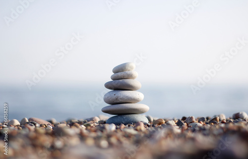 Stones tower with blurred sea background. Pyramid on the center. Zen garden. Spa set. 