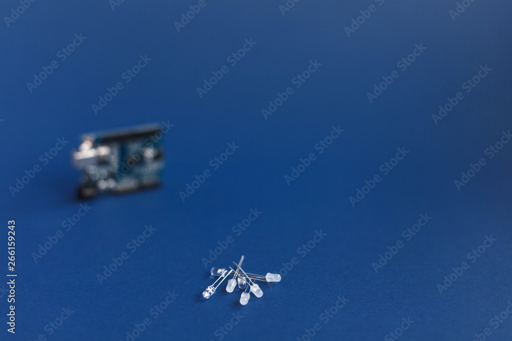 Diodes on blue background and Arduino uno Board for programming education development platform. Technology. Electronic computing machine. Concept Diodes on blue background and Arduino uno Board for programming education development platform. Technology. Electronic computing machine. Concept