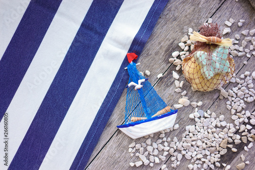 Fototapeta Naklejka Na Ścianę i Meble -  Sea Sand and Summer flat layout. Summer vacation concept with beach object and shower accessories such as sailboat, butterfly shaped soap, sponge and seashell.