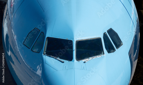 Closeup of the windows of a blue  airplane cockpit