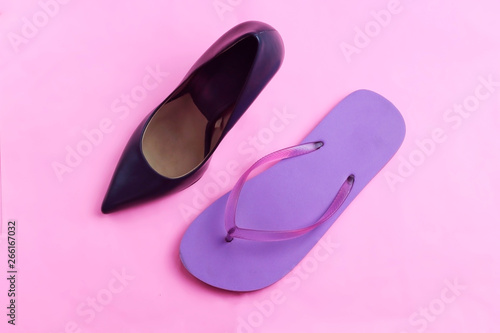 Trendy glamour fancy black classic glossy elegant high heels shoes and beach purple beach flip flops on pink background flat lay, high heel against flip flop healthy rested legs concept