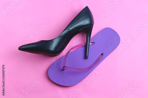 Trendy glamour fancy black classic glossy elegant high heels shoes and beach purple beach flip flops on pink background flat lay, high heel against flip flop healthy rested legs concept